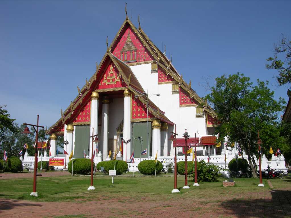 Bangkok 05 01 Ayutthaya Viharn Phra Mongkol Bophit Outside From its establishment in 1350 by King U-Thong (Ramathibodi I) until its fall to the Burmese in 1767, Ayutthaya was Thailand's capital and home to 33 kings and numerous dynasties. At its zenith and until the mid-18th century, Ayutthaya was a majestic city with three palaces and 400 splendid temples on an island threaded by canals -- a site that mightily impressed European visitors. Then, in 1767, after a 15-month siege, the town was destroyed by the Burmese and today there are but groups of crumbling ruins and rows of headless Buddhas where once an empire thrived. The temple compounds are still awe-inspiring even in disrepair and a visit here is memorable.<br/><br/>Ayutthaya�s Viharn Phra Mongkol Bophit was destroyed by the Burmese and rebuilt in its original architectures in 1956. Once upon a time, solemn cremation ceremonies of members of the royal family were held in the square in front.